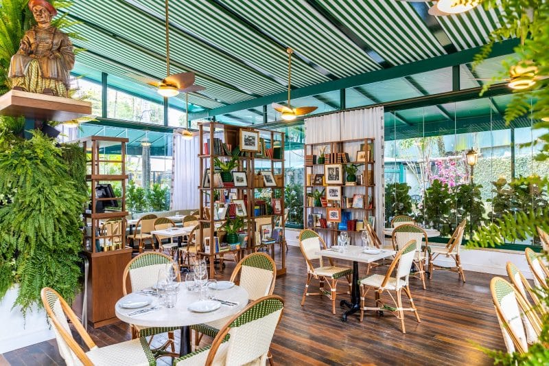 Ambiente interno do restaurante, que inclui uma pequena biblioteca